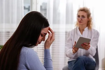 Woman talking with therapist during counseling for sexual trauma recovery.