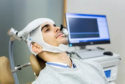 Man during transcranial magnetic stimulation therapy