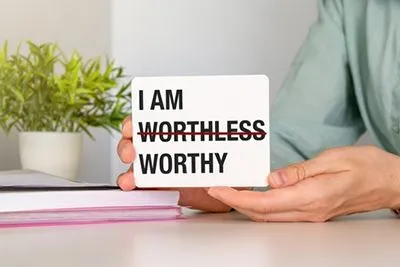 Female promoting self-esteem by replacing "worthless" with "I am worthy"