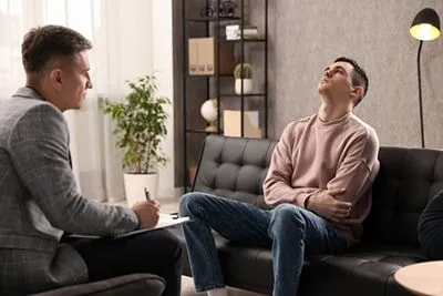Man with ADHD appearing distracted in therapy session