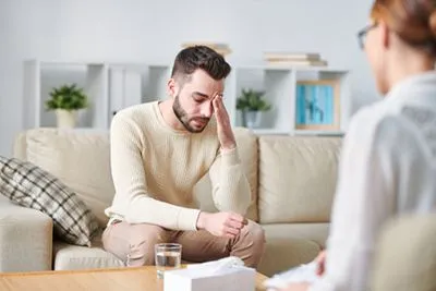 Man experiencing stress and anxiety during therapy session
