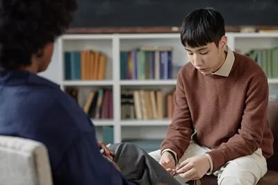 Mental health professional during teen therapy session