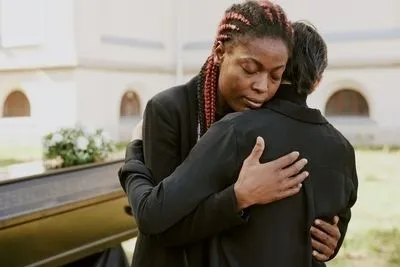 Woman in funeral hugging