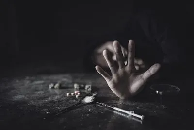 Man struggling with addiction, reaching out for help to overcome substance use.