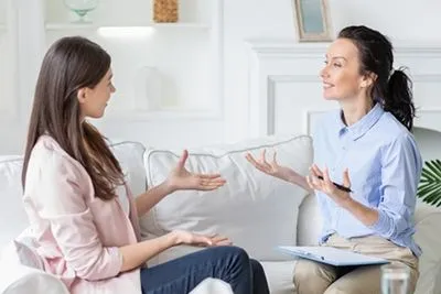 Happy Therapist talking with Client