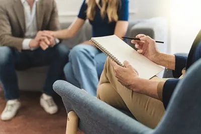 Couple sitting together with a relationship coach during a counseling session