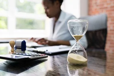 Time management concept illustrated by woman with ADHD and hourglass