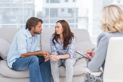 Couples talking to a therapist seriously