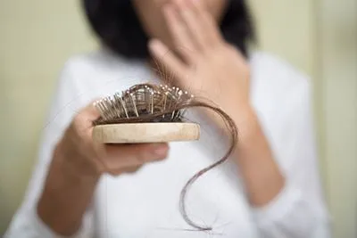 Woman loss hair in comb