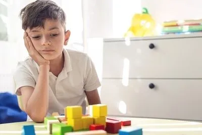 Child playing a colorful blocks on table