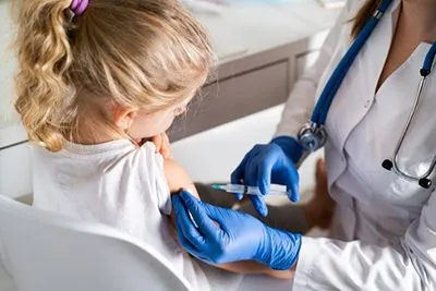 Young girl receiving immunization shot