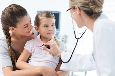 Little girl with mom during same-day sick visit with pediatrician