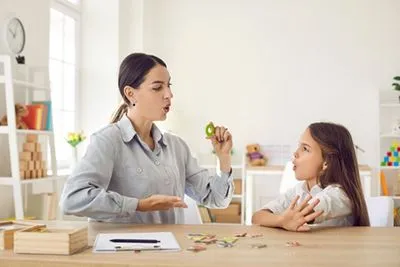 Pediatric doctor working with child on speech development