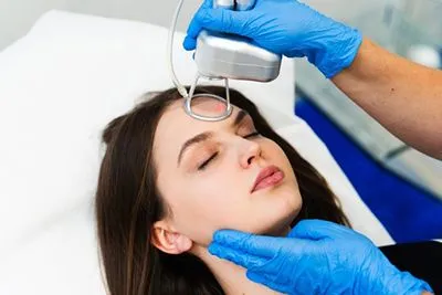 Female patient undergoing facial laser resurfacing treatment