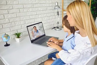 Mother and her child consulting on doctor online
