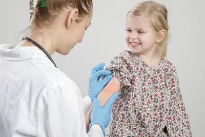 Pediatrician examining a child with a skin rash