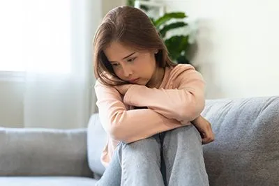 Depressed young girl showing signs of emotional distress and mental health struggles