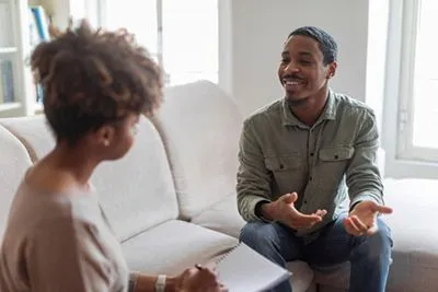Therapist providing life coaching session to male client