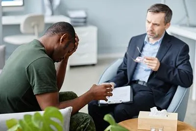 Military veteran receiving therapy for post-traumatic stress disorder and emotional trauma