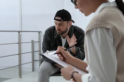 Young man in therapy session for substance abuse disorder