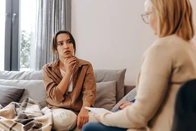 Adolescent in a supportive therapy session with mental health professional