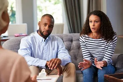 Young couple sitting together in a counseling session for marriage therapy