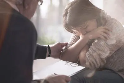 Woman in a therapy session seeking support for past sexual trauma.