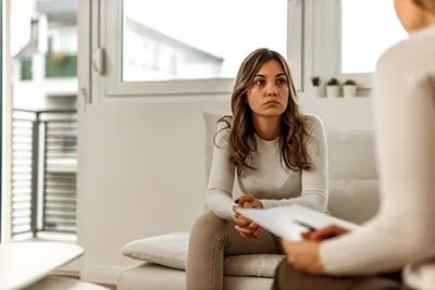 Female client seeking emotional support and guidance from a mental health professional.