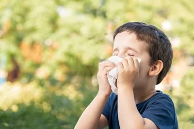 Child suffering from outdoor allergies caused by pollen