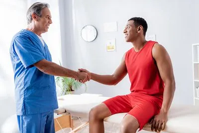 Man in athletic wear seeing chiropractor for performance health