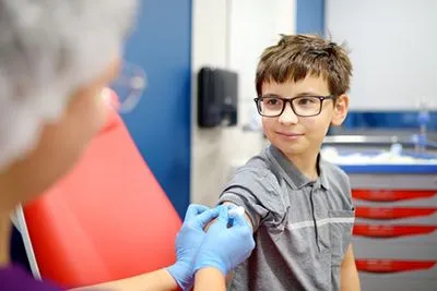 Child showing courage and joy during vaccination