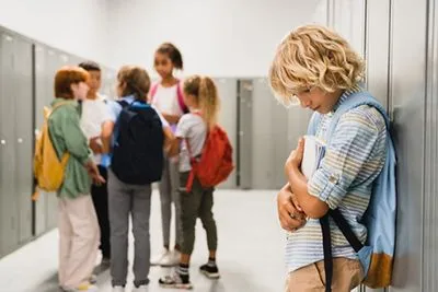 Child struggling to join group of children talking at school