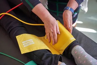 Patient undergoing ABI test to assess blood flow for PAD diagnosis