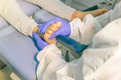 Doctor checking the foot of patient