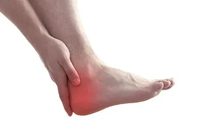 Man touching his heel in pain due to foot discomfort