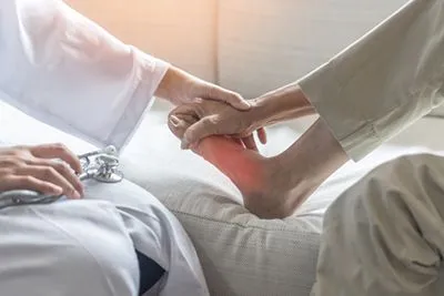 Podiatrist about to examine patient’s painful foot