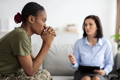 Therapist taking to a young woman with traumatic experience