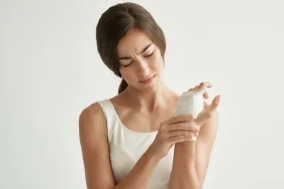 Woman feeling in pain with fracture on hand