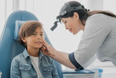 Pediatric ENT specialist examining a child’s ear