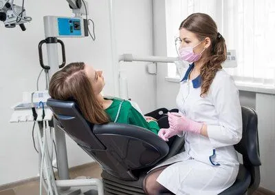 female hygienist working with female patient in dental exam chair, periodontics Narberth, PA gum disease treatment