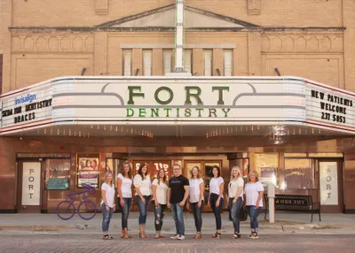 Dr. Walter Martin, DMD and his dental staff standing out front of Fort Theatre Dentistry building in downtown Kearney, NE