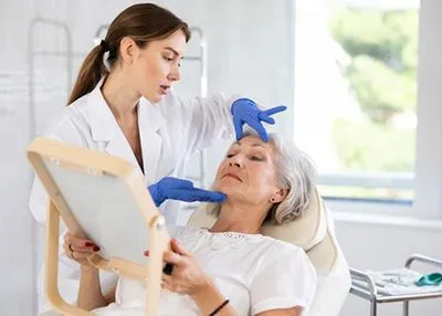 Dermatologist assessing a patient's facial wrinkles during a skin evaluation