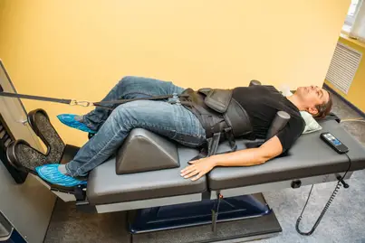 Patient undergoing Spinal decompression therapy in a chiropractic facility