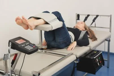 Woman undergoing Spinal Decompression in a chiropractic clinic