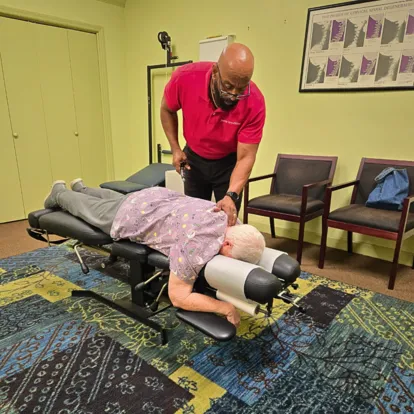 Stone Mountain Chiropractor for pain, injury and wellness Dr. Wilkerson treating patient