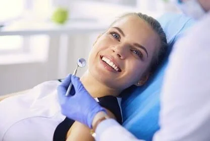 blond girl smiling, lying back in dental exam chair, teeth cleaning San Marcos, CA dentist