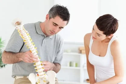 Male Doctor Explaining the Spine To a Patient