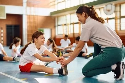 Little-girl-being-stretch-her-teacher-preparing-for-activities.