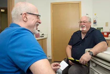 Paul Kapsar talking with patient