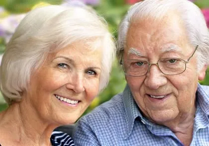 older couple outside smiling, Great Neck, NY dentures dentist